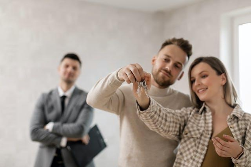 a couple holding a key